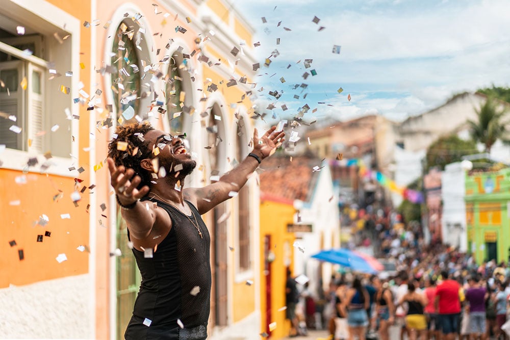 Someone enjoys their time at an event by throwing confetti.